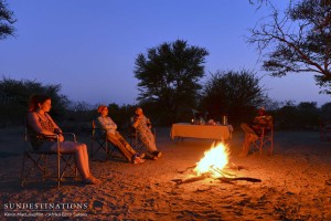 Surrounding the campfire after dinner