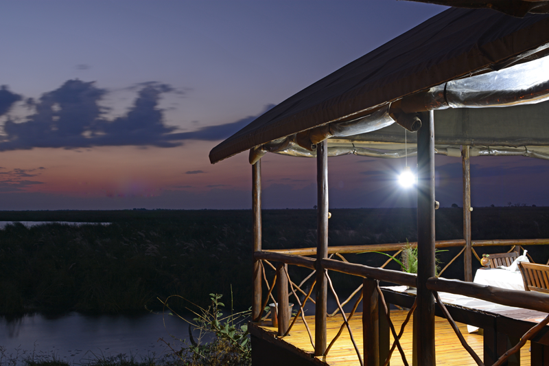 Settling in at Camp Linyanti for the night. The deck that overlooks the swamps all the way to the Caprivi Strip. Image by Kevin MacLaughlin.